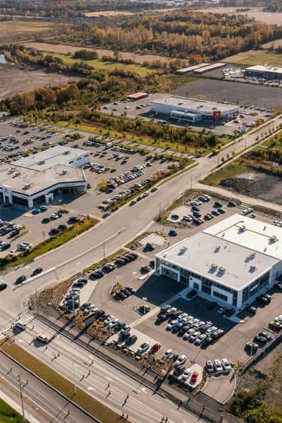 Aerial view of a commercial property showing parking areas, access roads, and boundary concerns reviewed during an ALTA survey